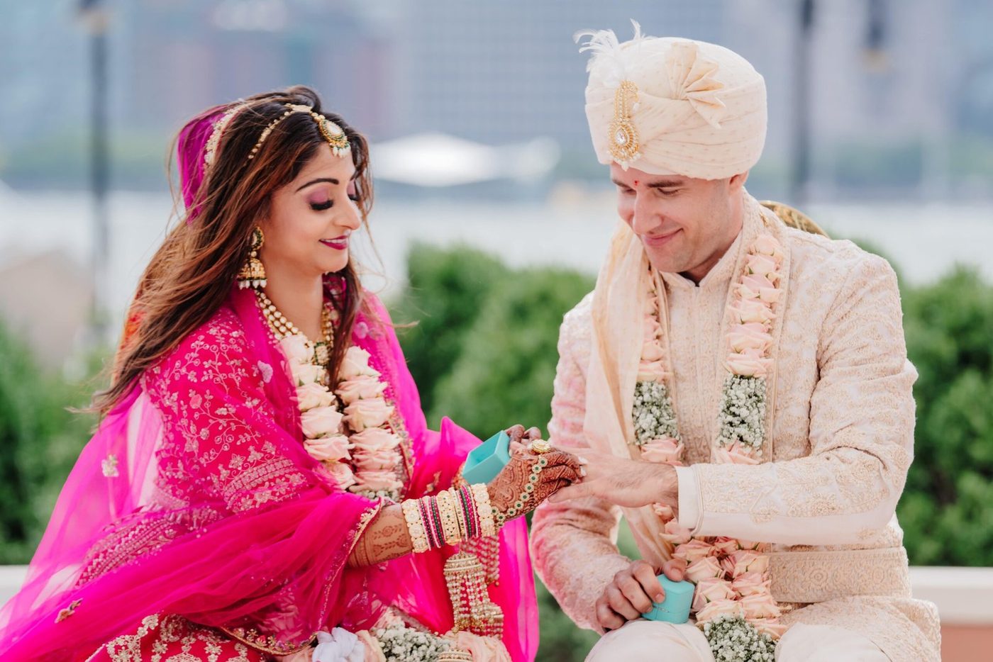 Couple exchanging rings at their engagement