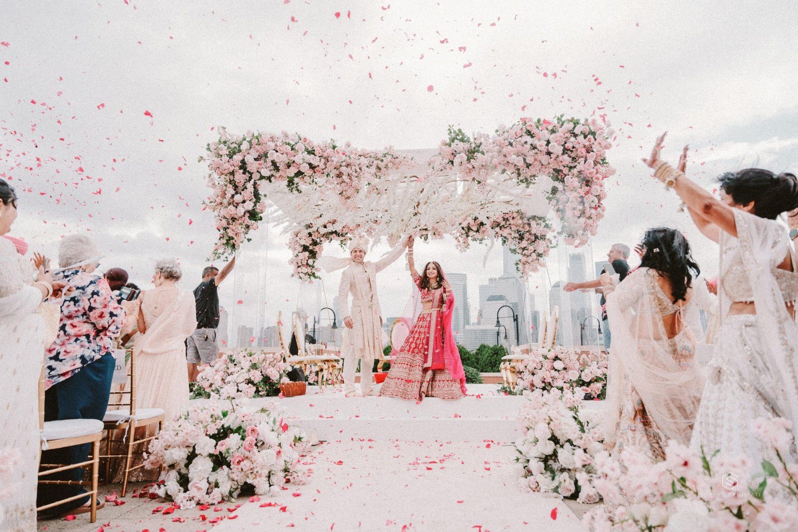 Petal shower over the couple at a floral mandap