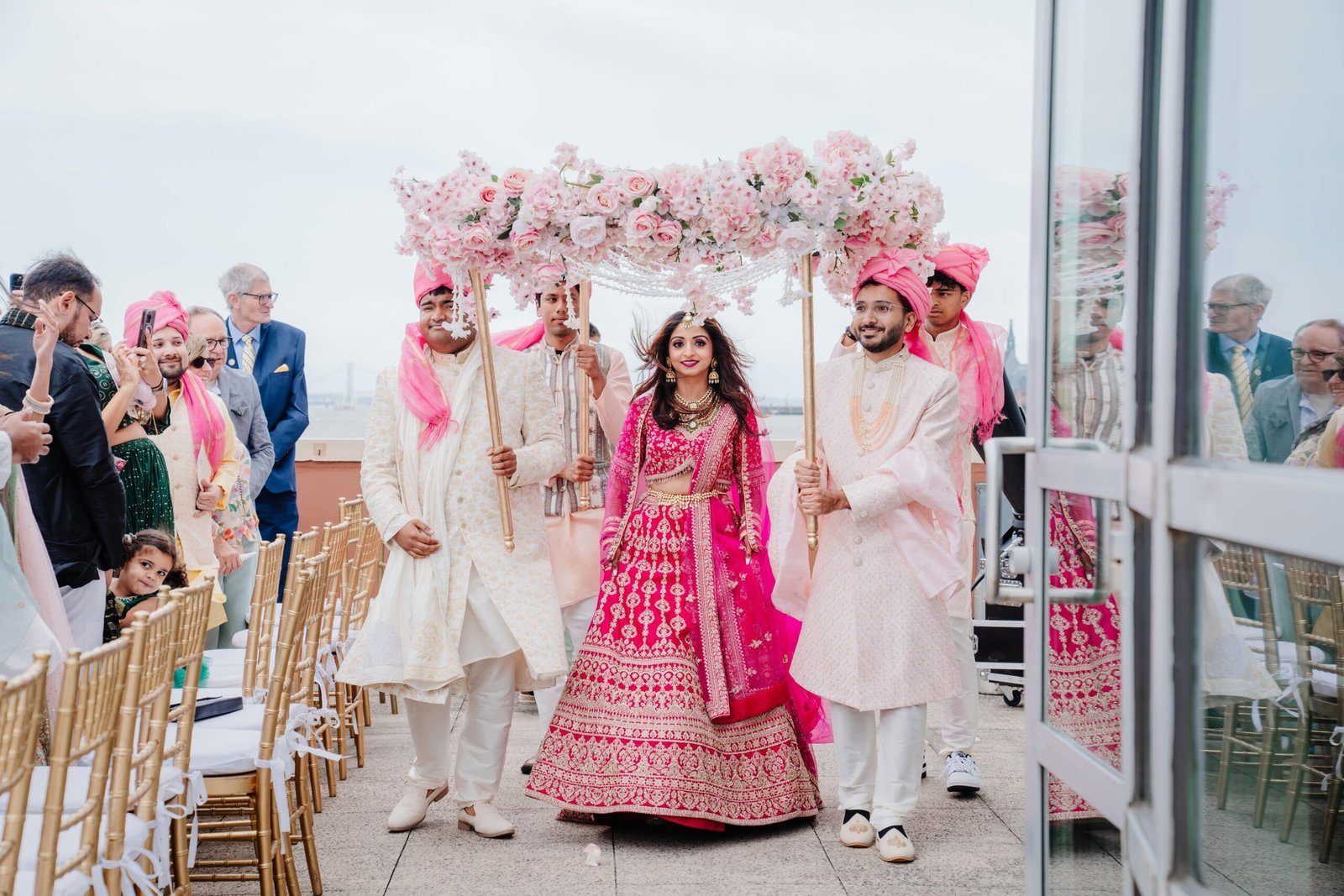 Blush floral mandap at a waterfront ceremony